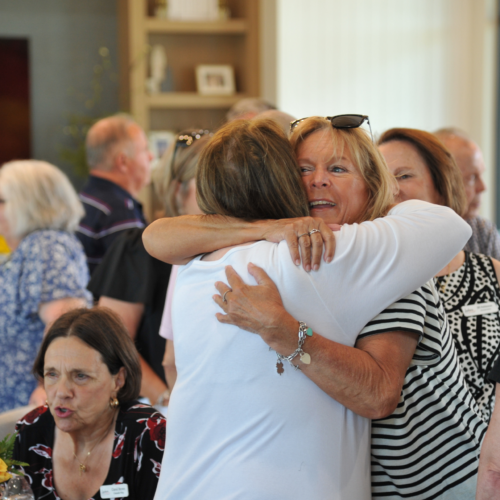 Women hugging at the HUB