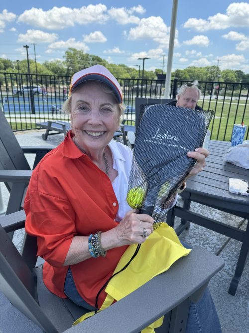 woman holding up Ladera pickleball racket