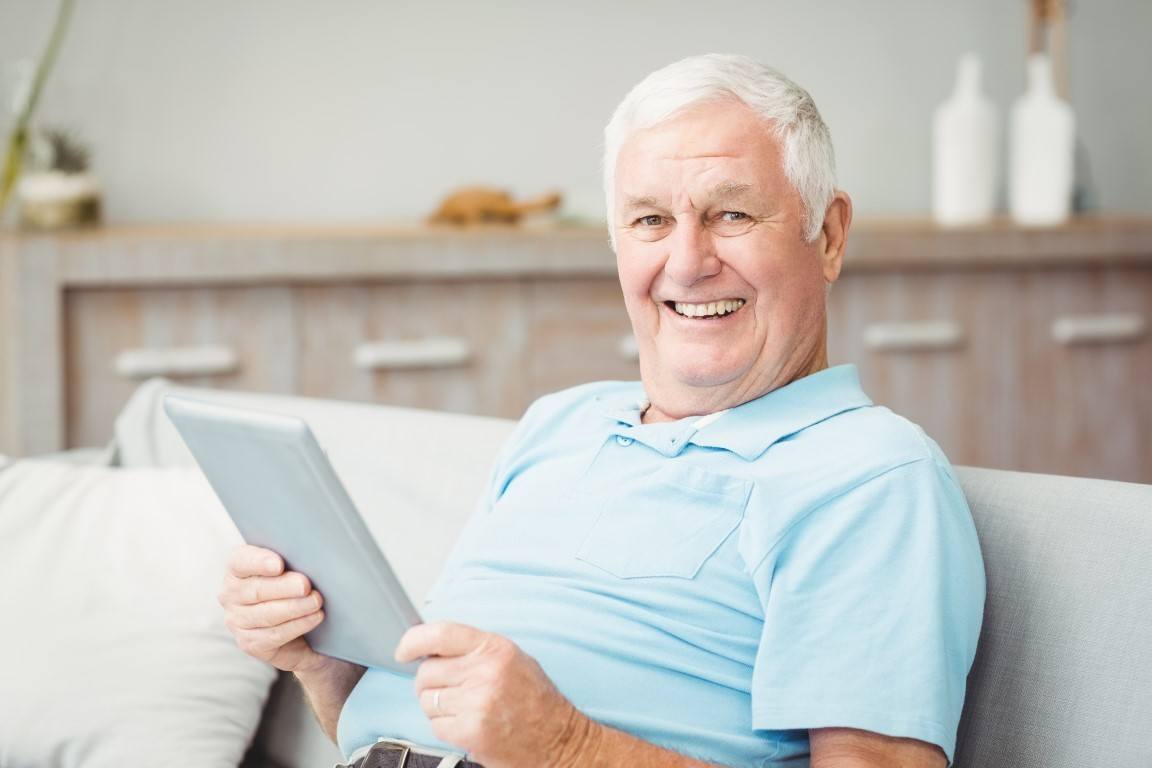 Ladera Texas - Active Adult Enjoying His Home holding A Tablet