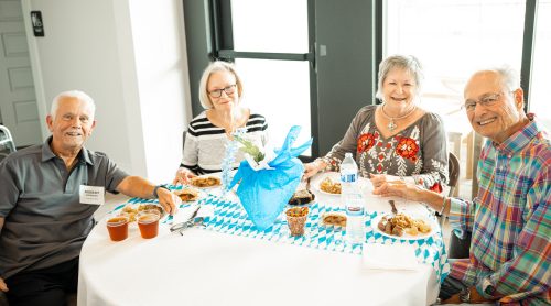 four people smiling at Octoberfest event