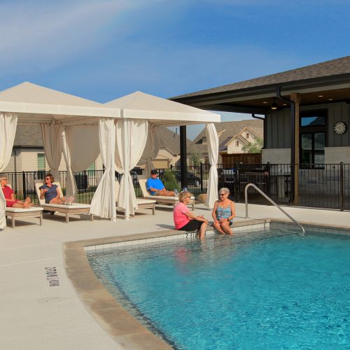 Friends gathered in and around pool