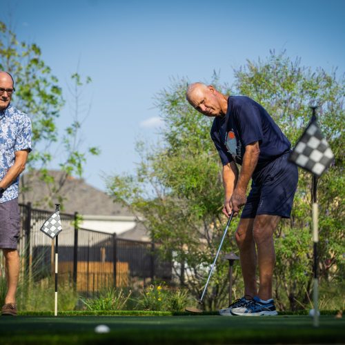 two men putting golf balls