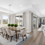 Elegant dining area at Ladera Living with natural light, modern decor, plush seating, and views of the backyard patio