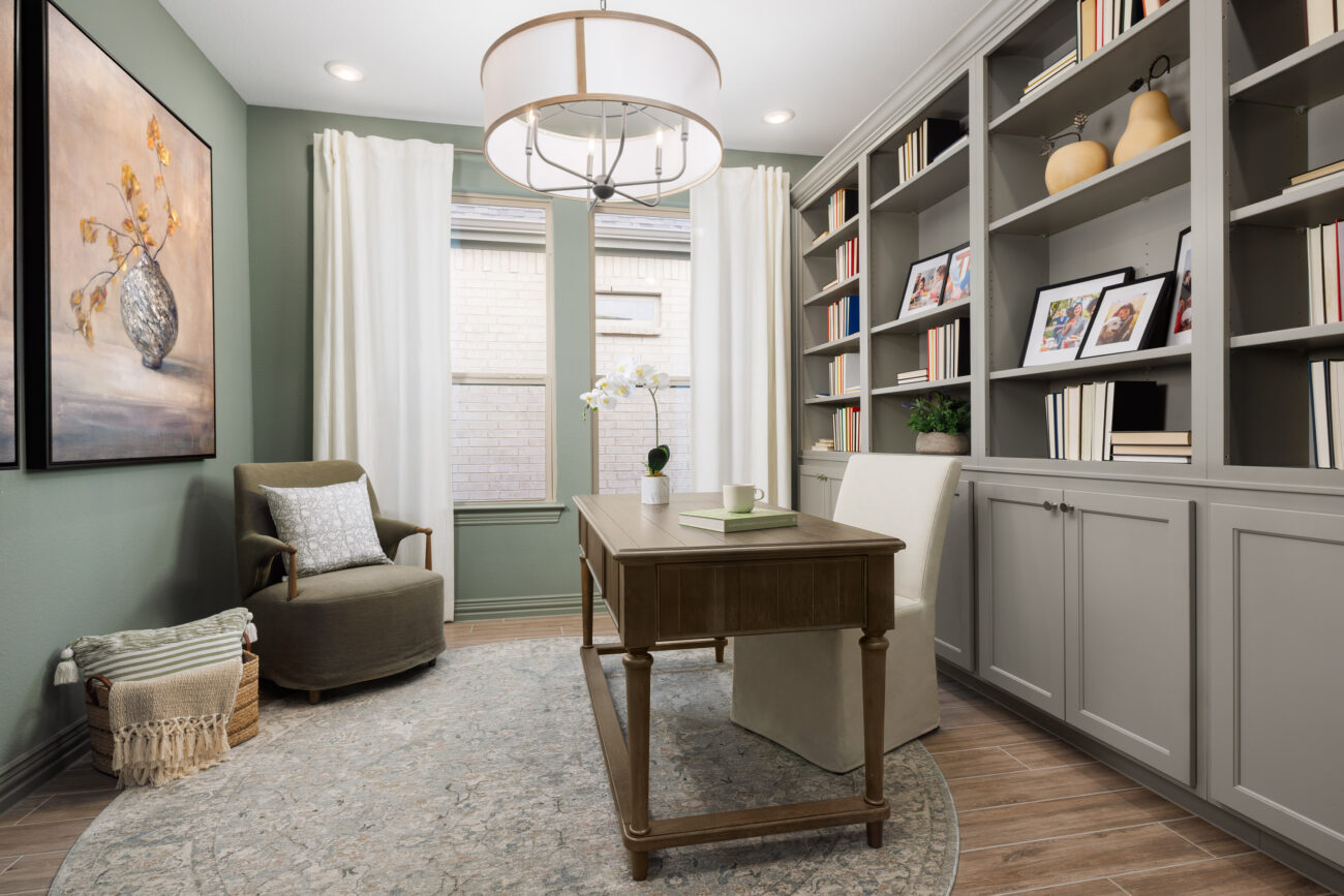Modern home office with built-in bookshelves, wood desk, and natural light, showcasing Ladera Living interior design