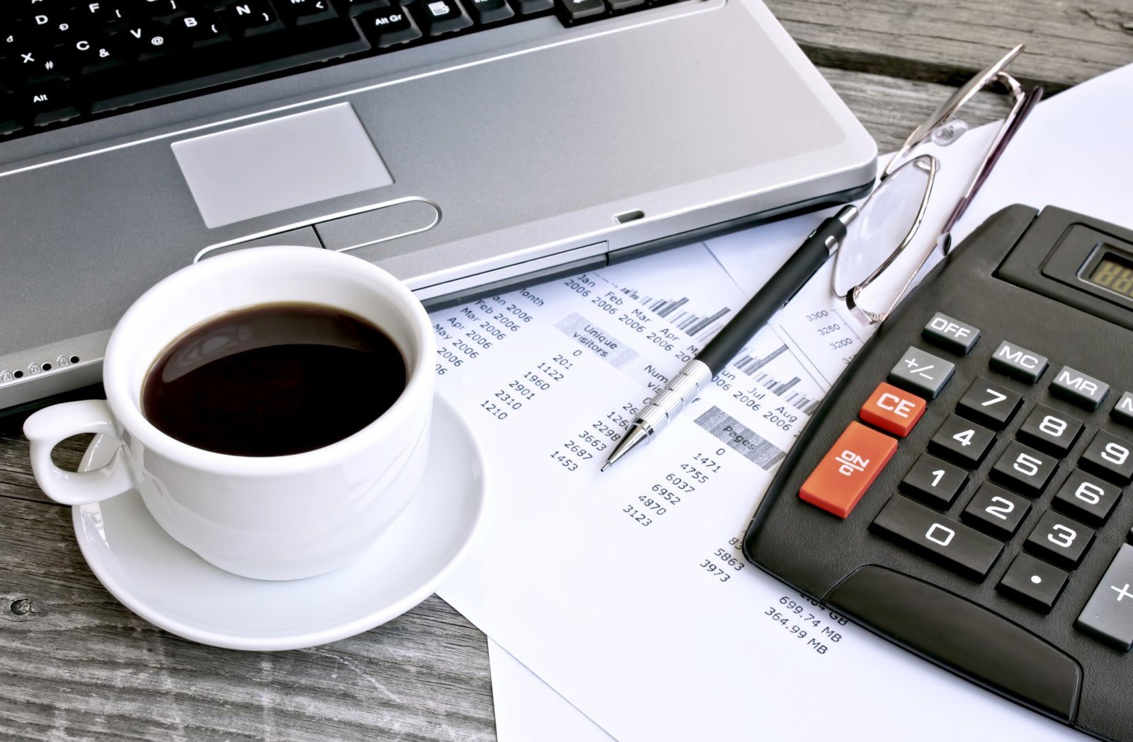 a-busy-computer-table-with-hot-coffee-and-glasses