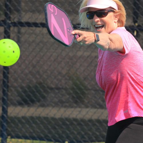 woman hitting pickleball