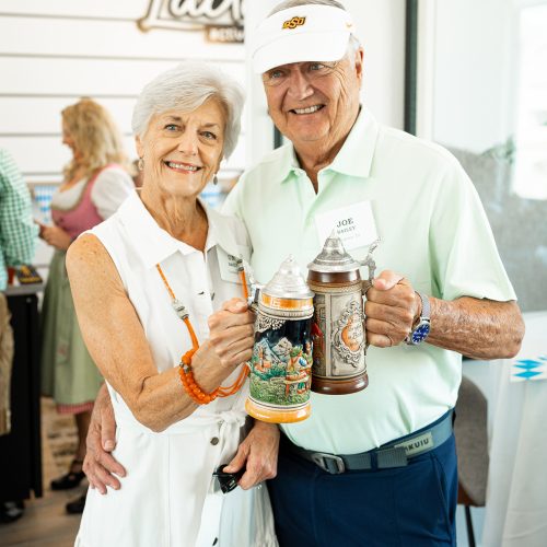 couple toasting with steins at Octoberfest event