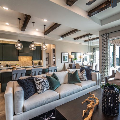 Living room and kitchen with high ceilings and exposed beams