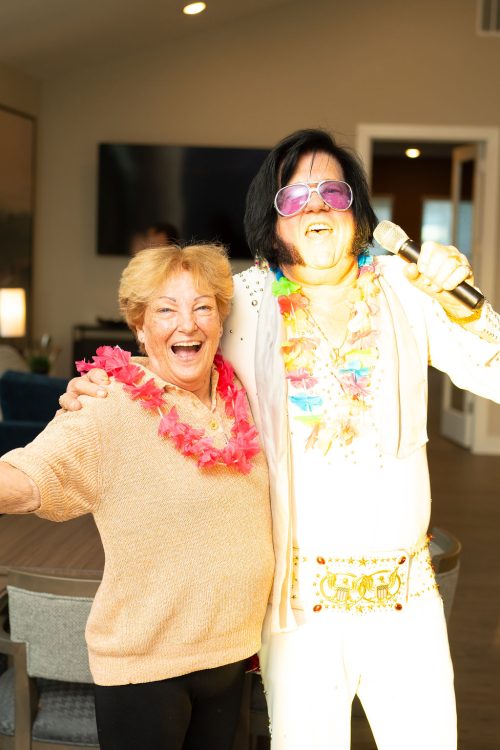 woman posing with Elvis impersonator