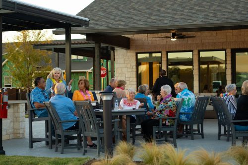 groups seated at tables at outdoor event