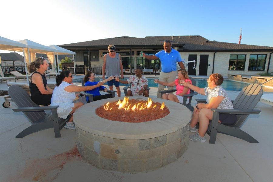 group of people gathered around firepit