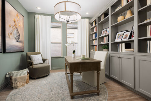 Modern home office with built-in bookshelves, wood desk, and natural light, showcasing Ladera Living interior design