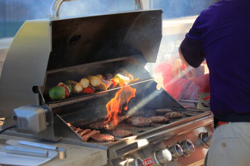 grilling hamburgers, hotdogs and vegetables