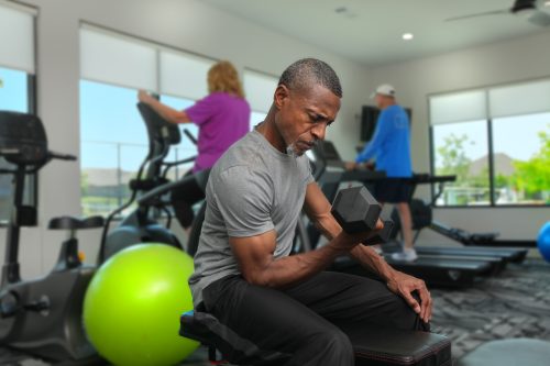 man doing bicep curls with dumbell