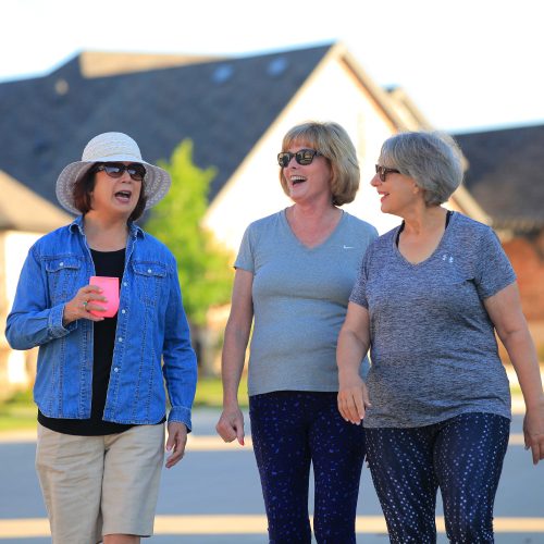 three women walking and laughing