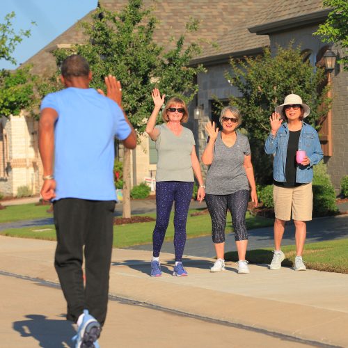 neighbors waving to man running