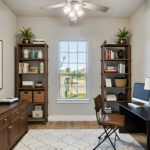 Home office with desk, bookshelves, ceiling fan, and natural light, styled for productivity in a Ladera Living home