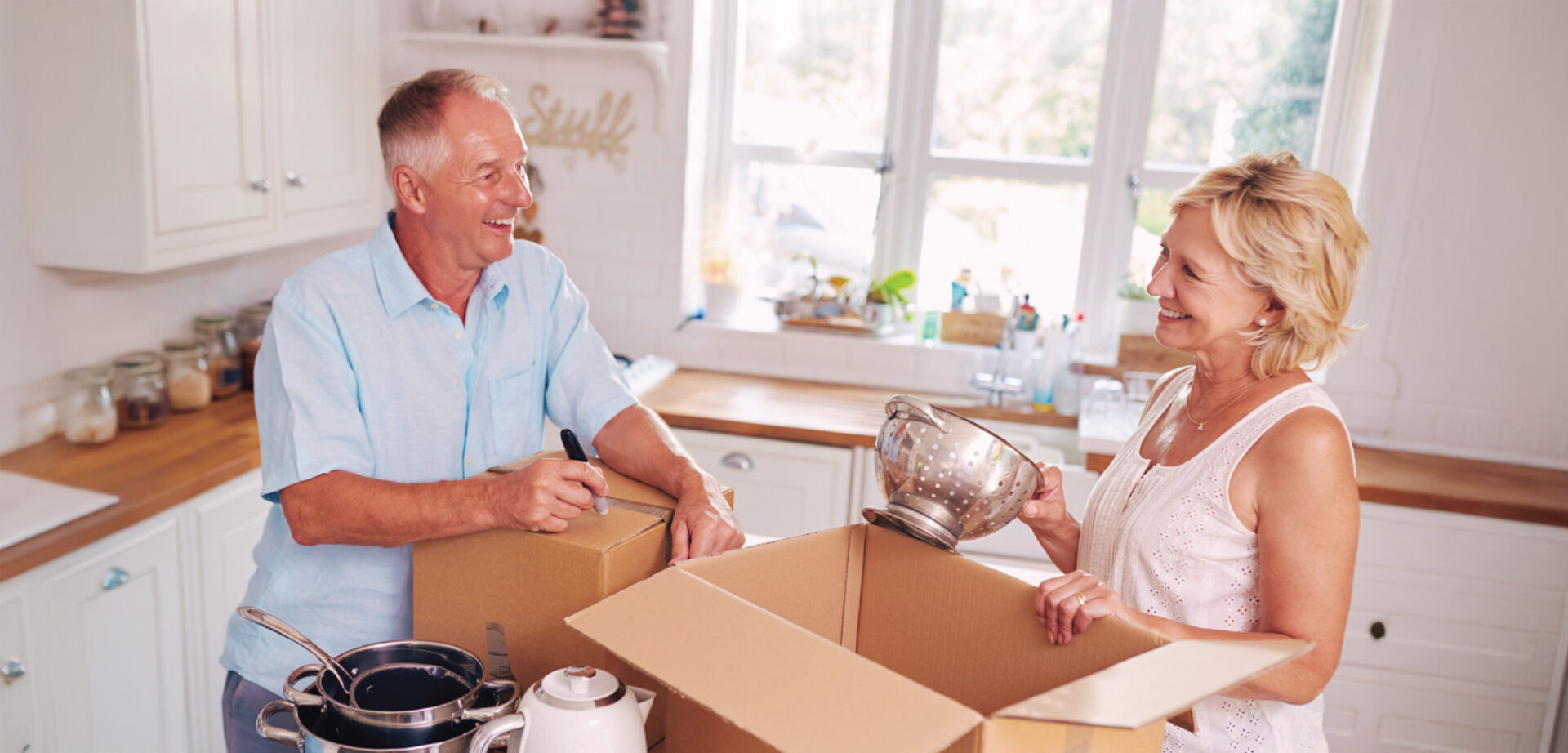couple boxing up kitchen items