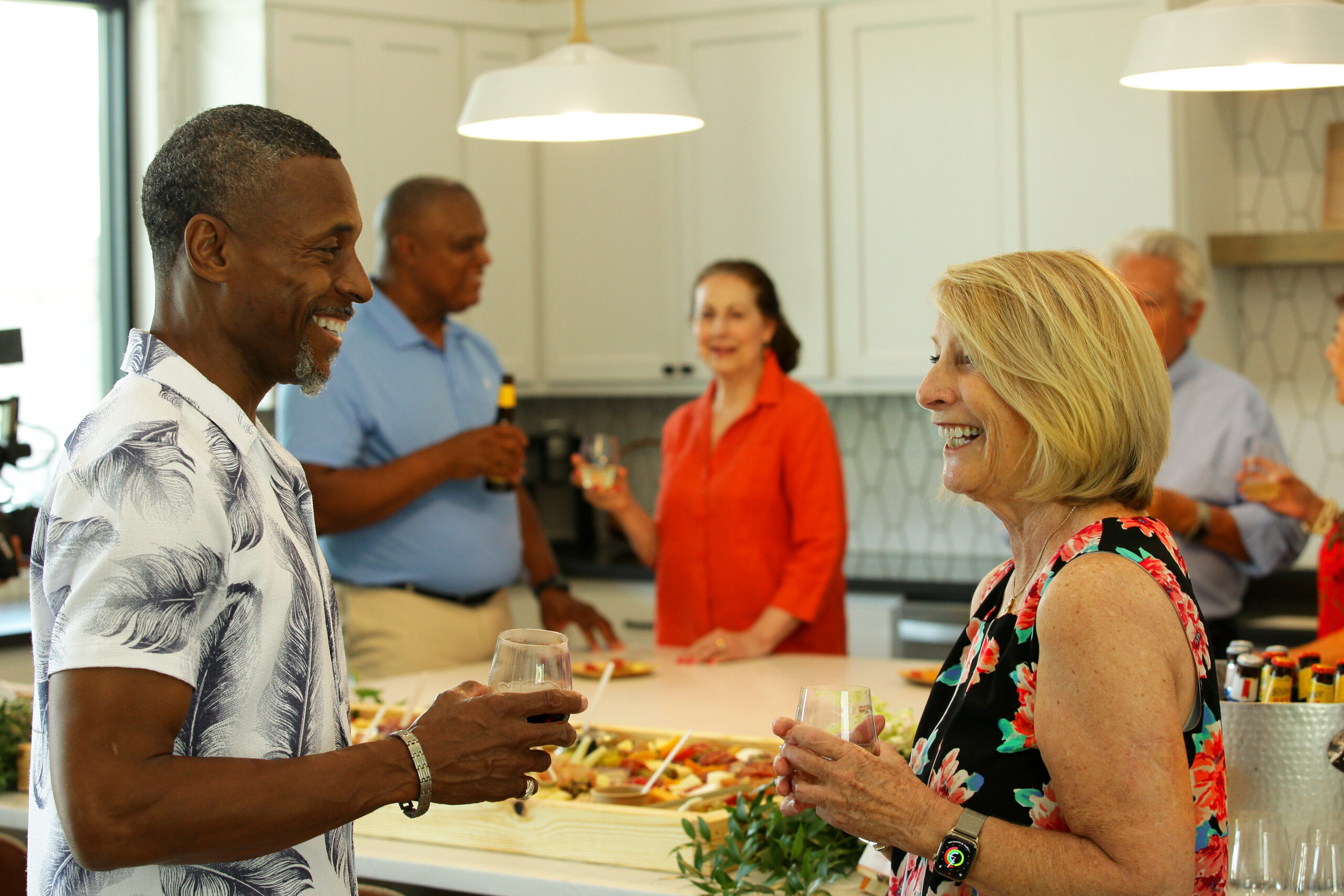 Woman and man talking at a party. Low-Maintenance Living in Ladera Living communities