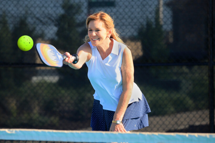 Woman playing pickleball - Ladera Living communities
